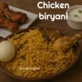 No tomato chicken biryani served in a rustic brass pot with fluffy basmati rice, garnished with mint and fried onions – South Indian Sunday lunch style.