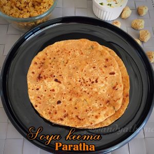 Soya keema paratha served hot with raita on a rustic plate — healthy vegetarian Indian stuffed flatbread