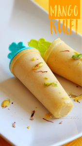 Close-up of homemade mango kulfi in steel molds with visible saffron threads and nut bits