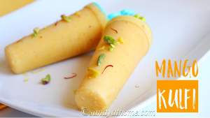 Frozen mango kulfi sticks on a wooden tray with melting edges and a summery yellow hue