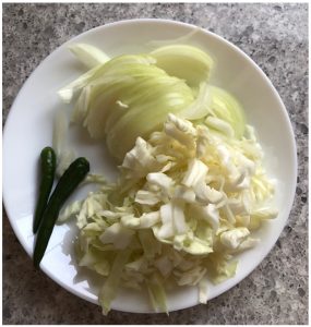 chop veggies for cabbage biryani