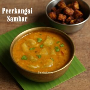 Peerkangai Sambar served in a brass bowl with hot steamed rice and ghee, garnished with fresh coriander leaves.