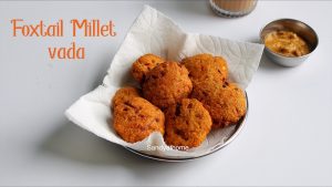 Crispy Thinai Vadai served on a banana leaf with coconut chutney and ginger tea