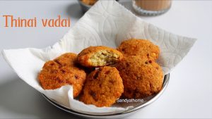 Crispy Thinai Vadai served on a banana leaf with coconut chutney and ginger tea