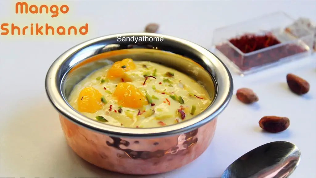 Creamy mango shrikhand served in a bowl with pistachio and saffron garnish
