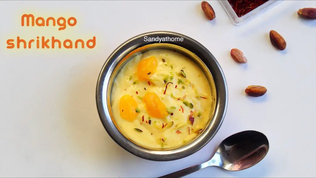Amrakhand in brass bowl with spoon on the side, styled for Indian festive dessert