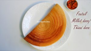 Crispy thinai dosa served on banana leaf with coconut chutney on the side