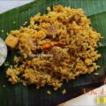 Rustic plated Arcot Nawabi Vegetable Biryani served on banana leaf, paired with authentic brinjal raita, representing Tamil-Mughal fusion cuisine.
