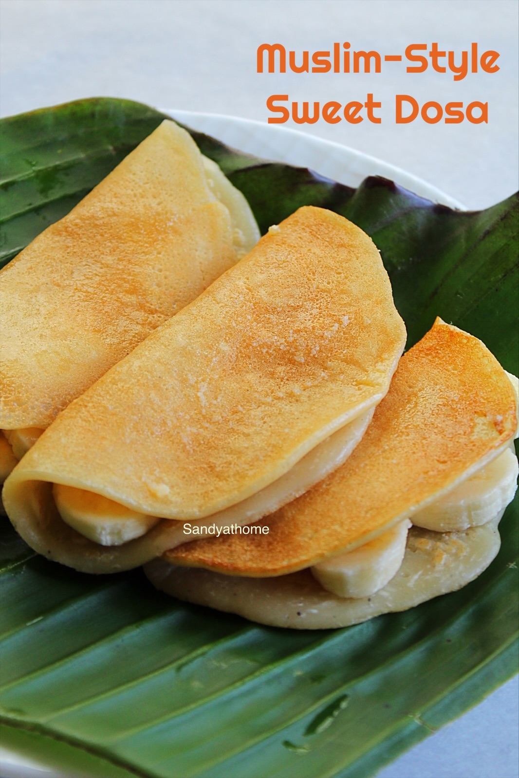 Folded maida sweet dosa with banana, served on banana leaf in Tamil Muslim style