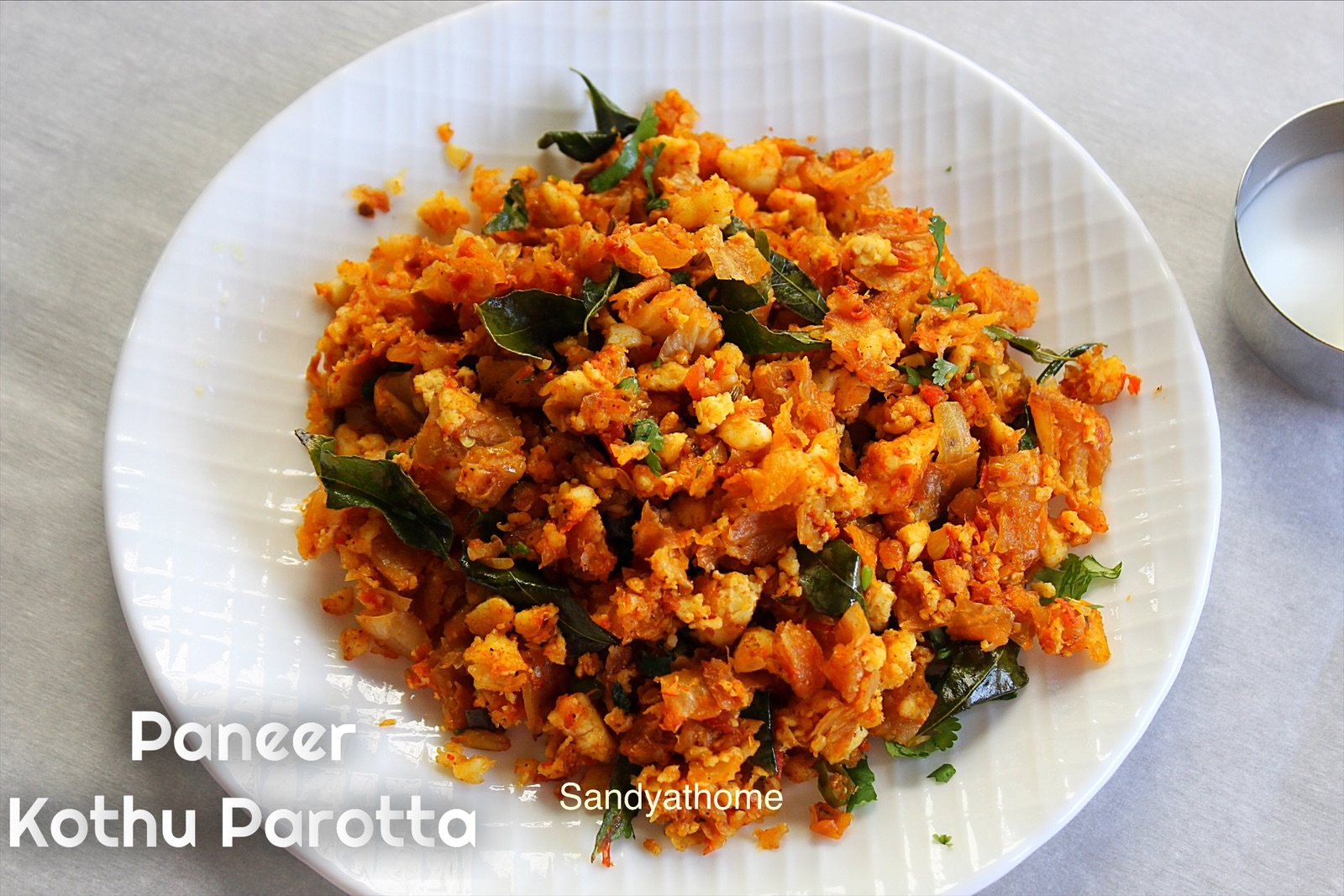 Quick and easy paneer kothu parotta made with crumbled paneer and parottas, ready to serve hot with raita.