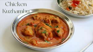 Rustic Muslim-style chicken kuzhambu in clay pot with curry leaves and coconut masala, served hot for Bakrid