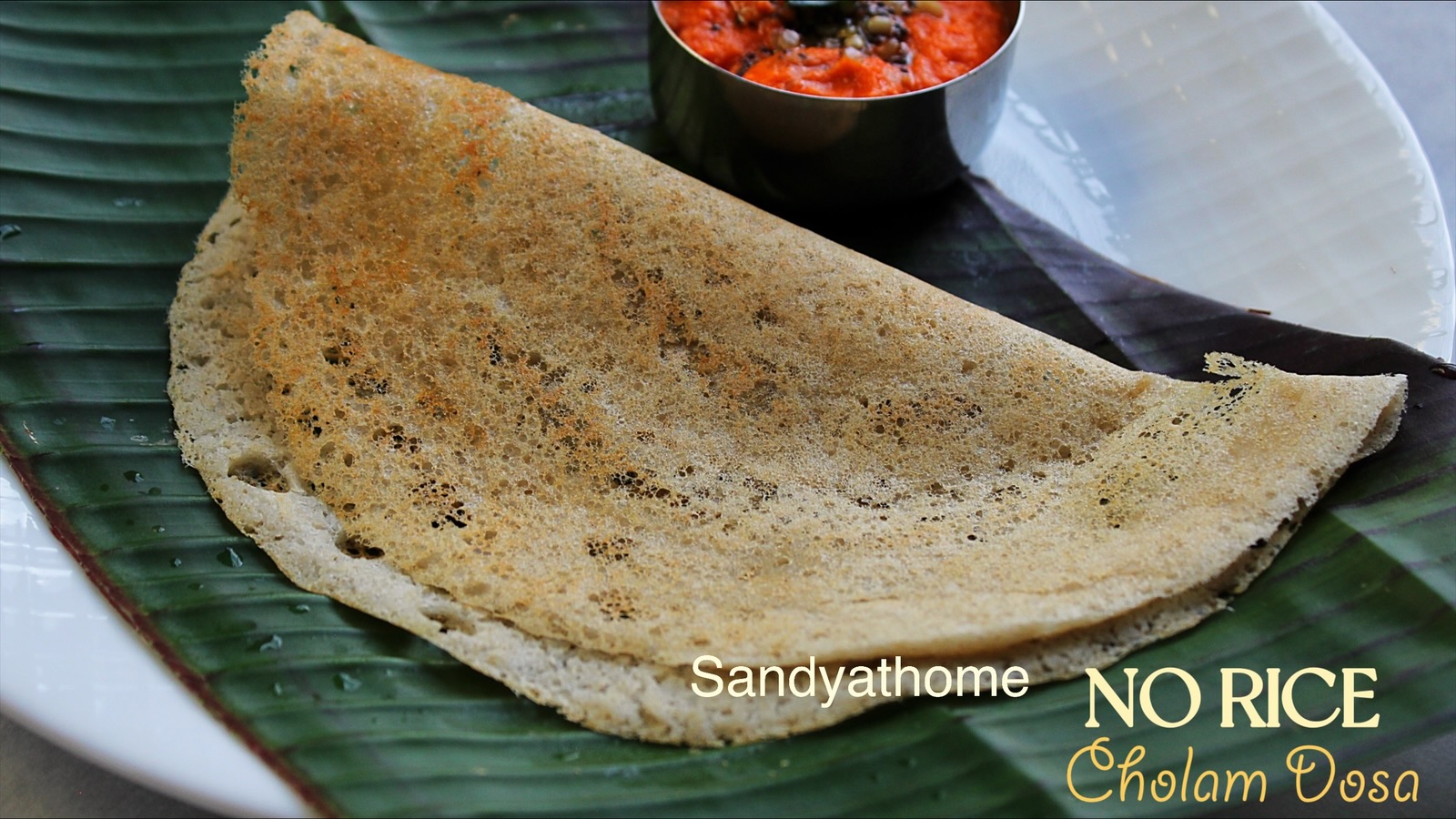 Golden crisp jowar dosa cooking on tawa, no rice millet dosa, healthy vegan Indian breakfast