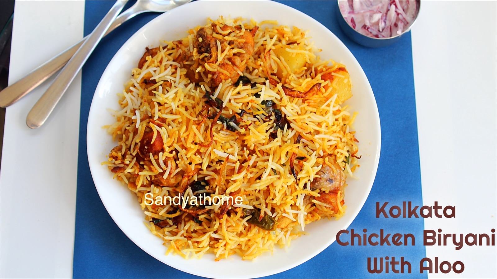 Kolkata chicken biryani with fried potatoes and a halved boiled egg, showcasing the Nawabi-style presentation.