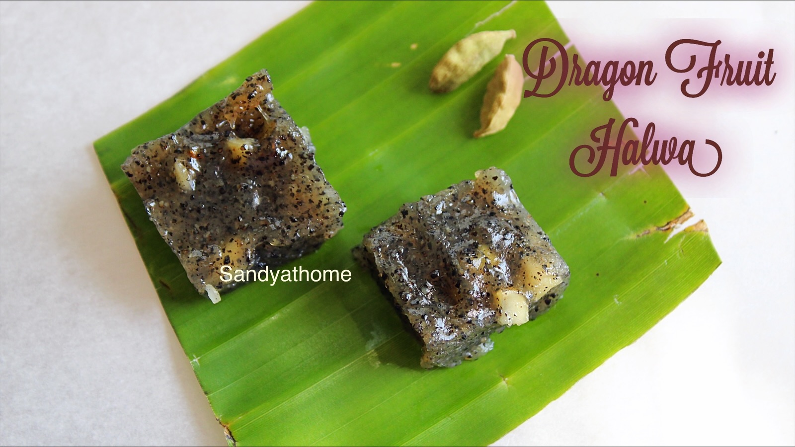 Dragon fruit halwa made with cornflour, brown sugar, and ghee, set into glossy squares and served on banana leaf – a traditional Indian fusion dessert recipe by Sandyathome.
