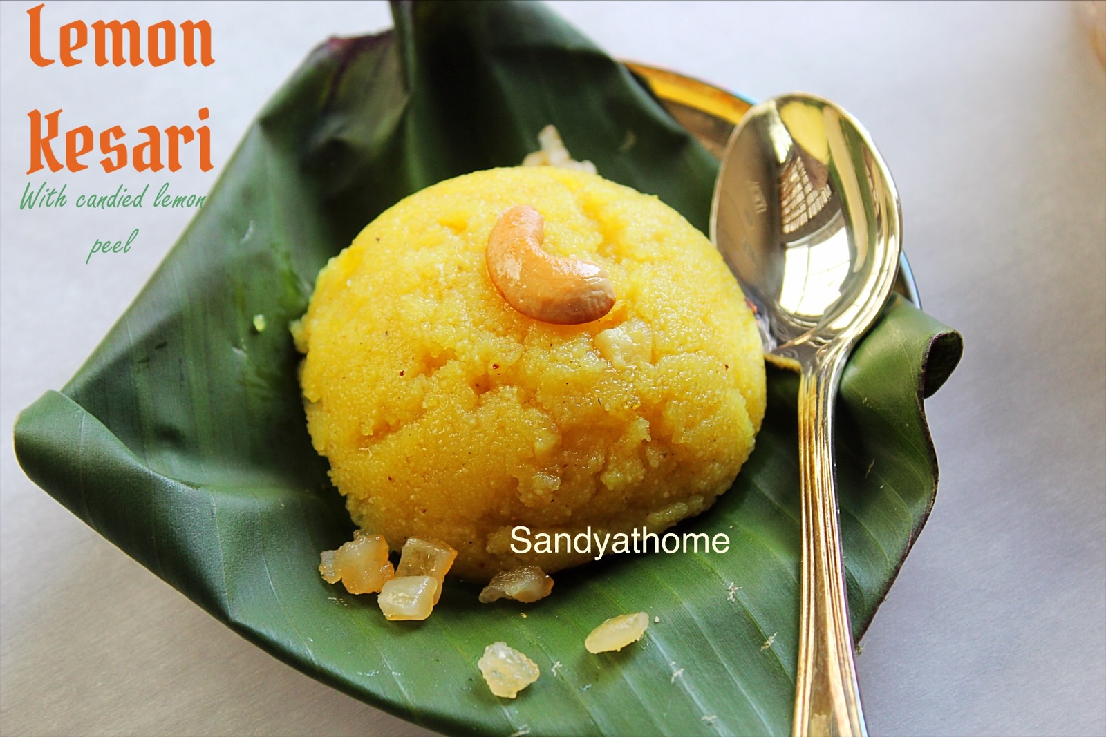 Golden sheera made without food color, placed on a rustic wooden tray with cardamom pods and lemon slices