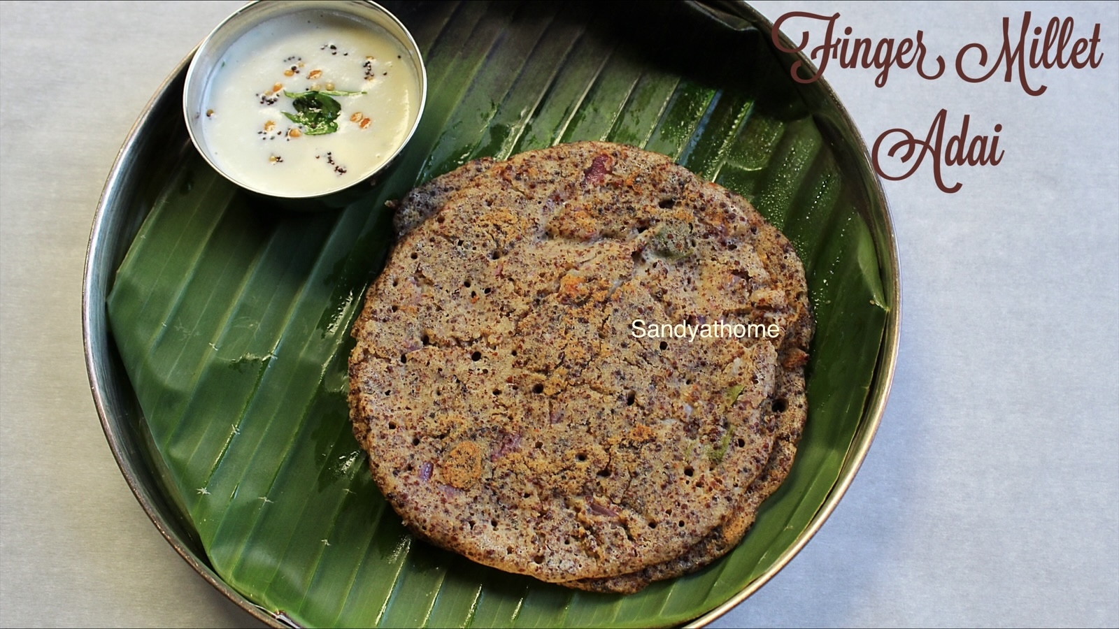 Stacked crispy millet adai made with kezhvaragu and kuthiraivali – gluten-free, high protein South Indian dish.
