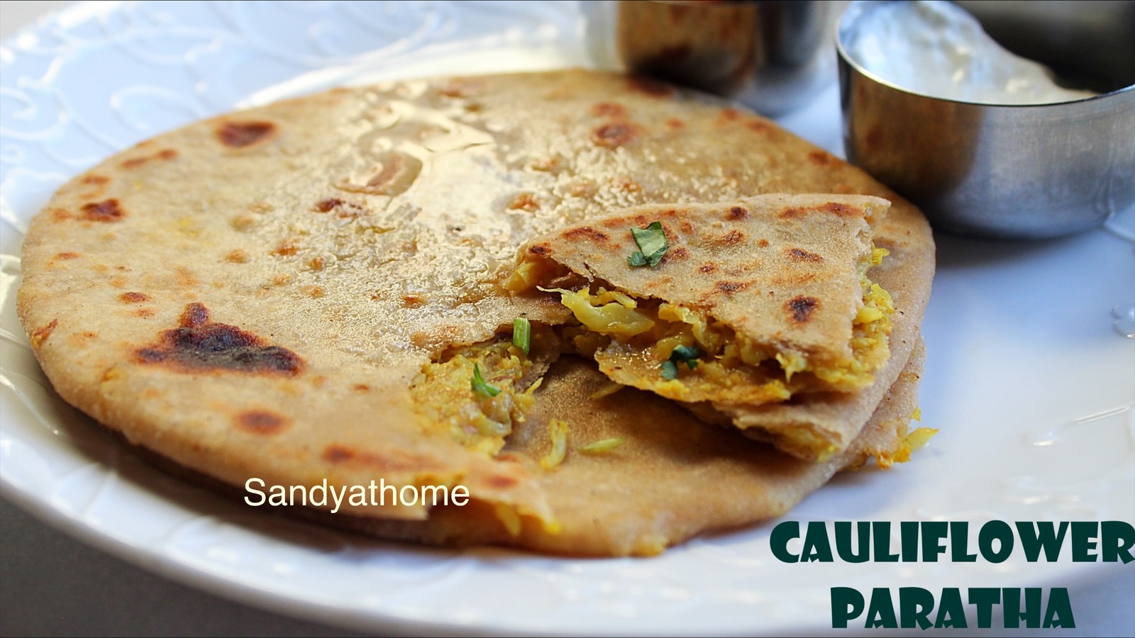 Traditional North Indian breakfast with gobi paratha, butter, and masala chai