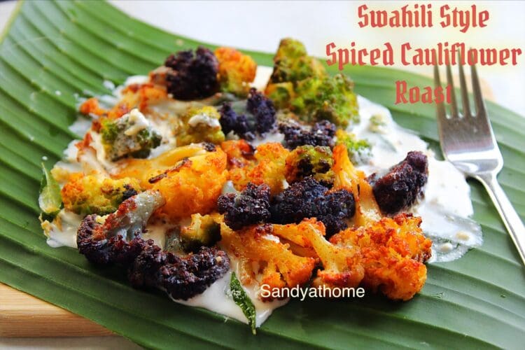 Swahili-inspired roasted colorful cauliflower served on banana leaf with creamy cashew-curd sauce — African Indian fusion appetizer with bold spices.