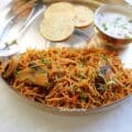 Close-up of vermicelli biryani with mushrooms – no rice biryani garnished with mint and served with raita