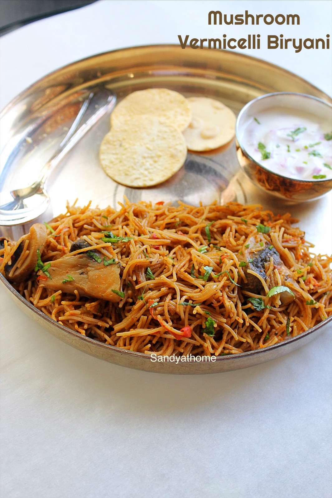 Close-up of vermicelli biryani with mushrooms – no rice biryani garnished with mint and served with raita