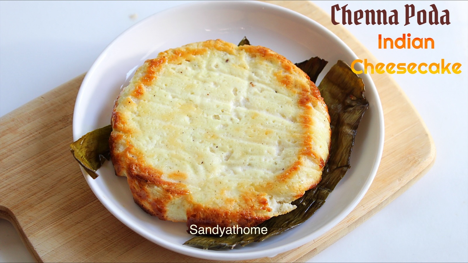 Chenna Poda baked in banana leaf — traditional Indian burnt cheesecake dessert with caramelised crust, fresh chenna, and sugar.
