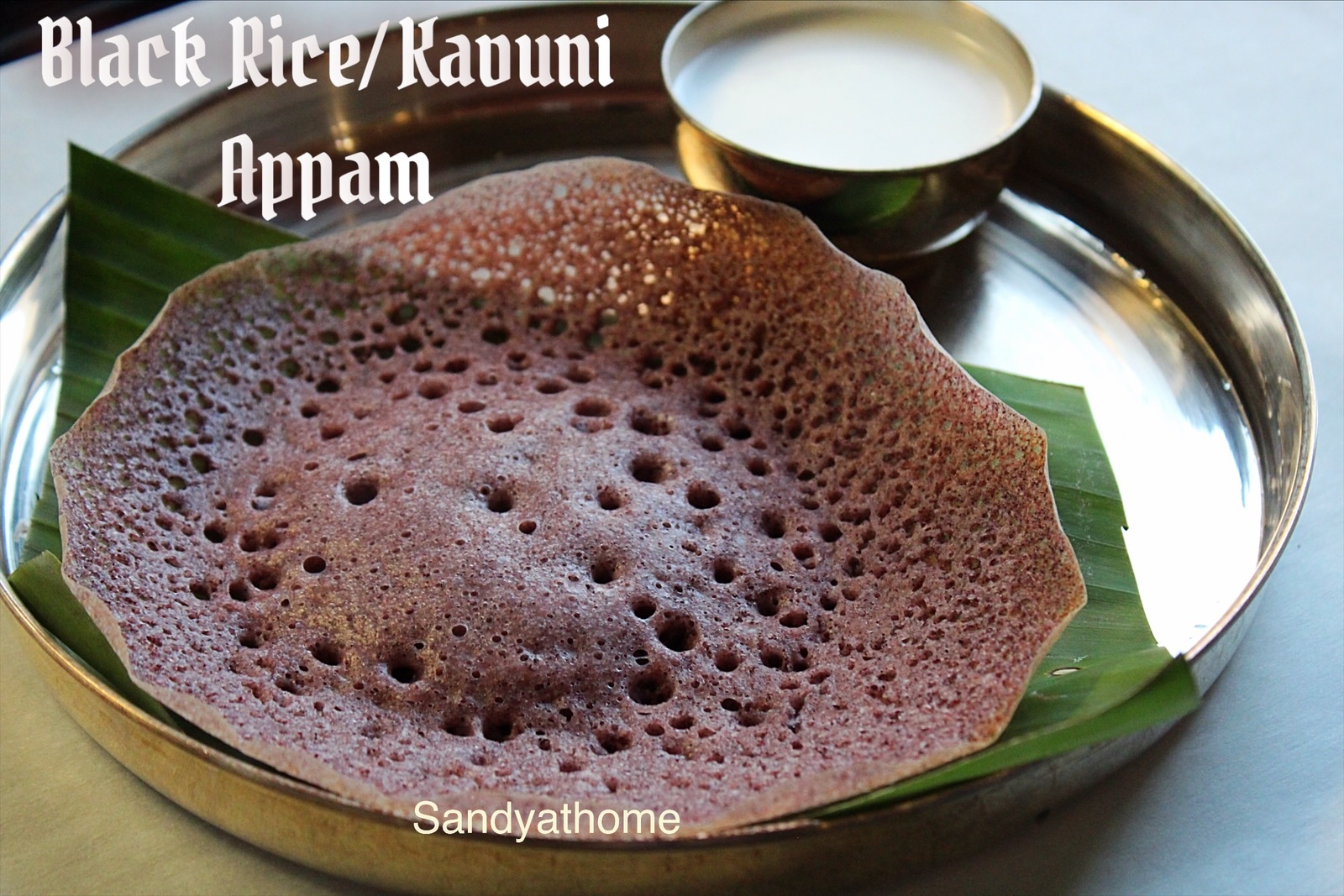 Traditional Chettinad black rice appam paired with coconut milk, a wholesome fermented Tamil breakfast dish.