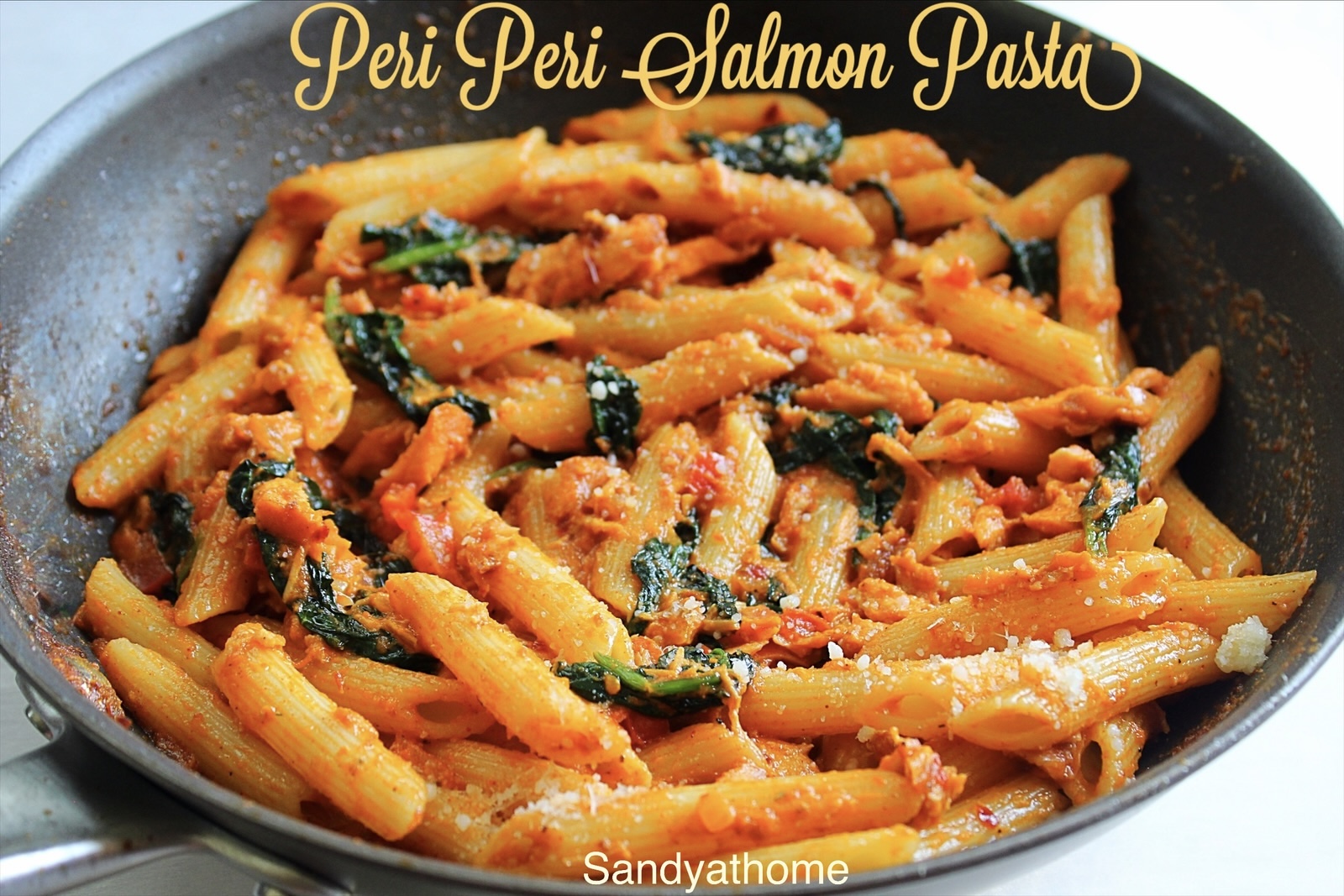 A quick and spicy fish pasta dish with creamy tomato sauce and seared salmon, ideal for weeknight dinners.