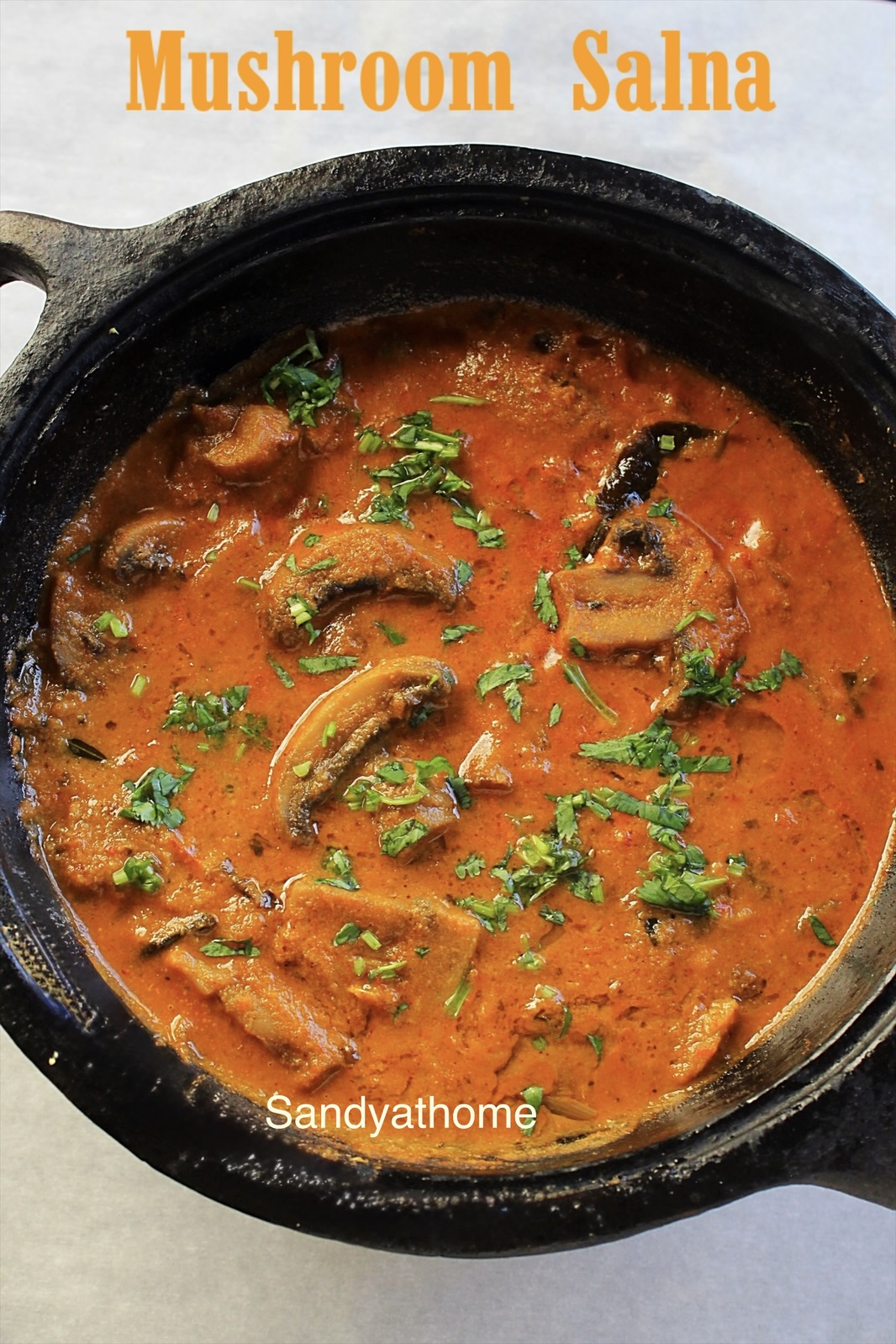 Hotel-style mushroom salna with rich masala and garnished with coriander – parotta salna close-up shot.