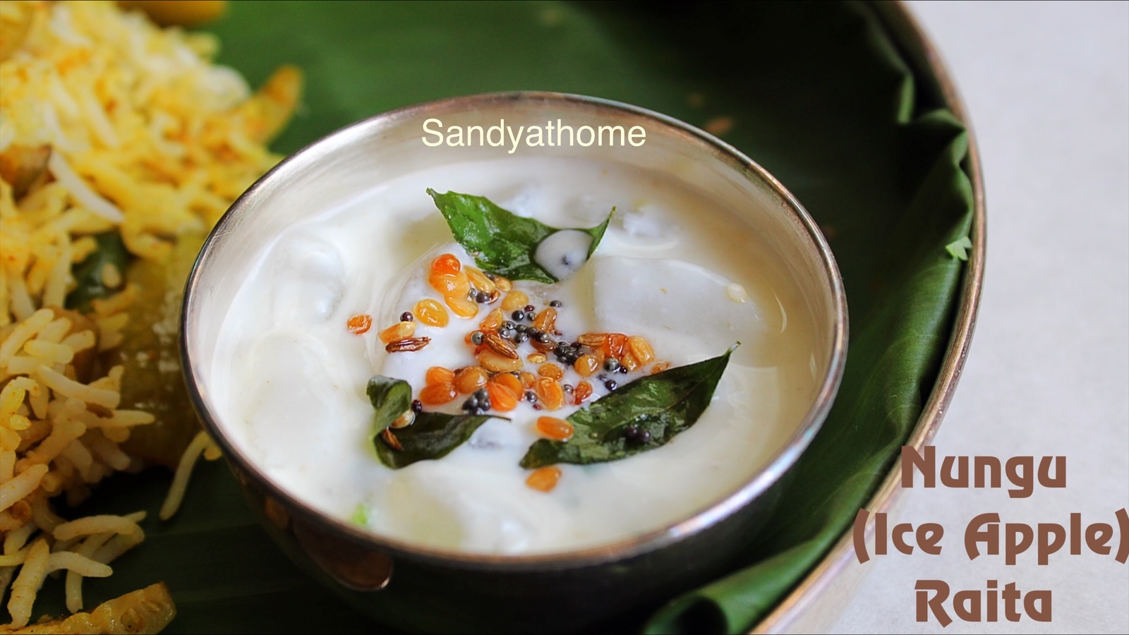 nungu raita / Ice apple curd raita with green chili and curry leaves in a brass bowl – a cooling no onion no garlic South Indian summer dish.