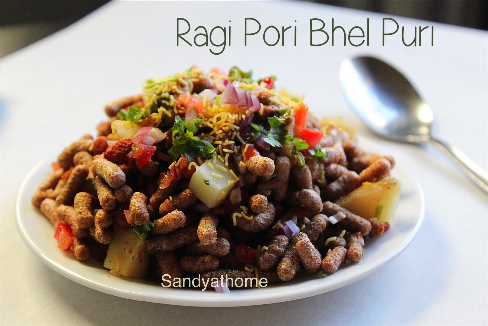 Millet bhel puri made using ragi pori, served as a traditional Indian street food chaat with chutneys and sev.