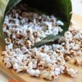 Millet popcorn served in a banana leaf cone – a traditional Indian millet snack made from puffed sorghum using a pressure cooker, oil-free and healthy.