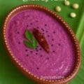 A bowl of vibrant purple naval pazham chutney served on a banana leaf – traditional Tamil chutney recipe made from jamun fruit.
