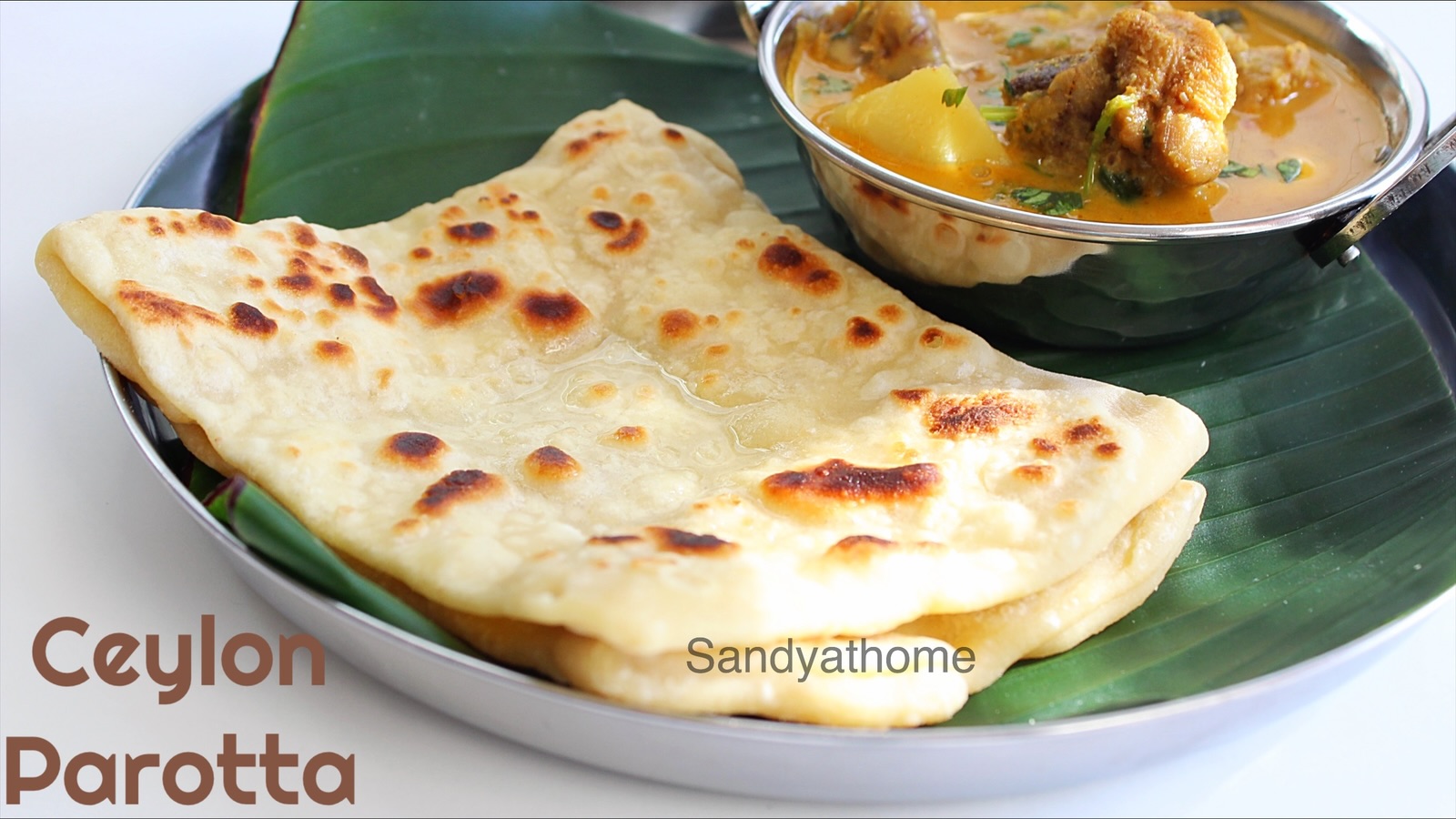 Flaky Ceylon parotta folded in square style, made with egg dough, served hot on a banana leaf – a Tamil street food classic.
