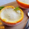 Scoopless orange ice cream made without molds or machines, set inside orange halves, topped with mint