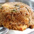 South Indian-style vegetarian keema biryani made using soya granules and aromatic spices, served in a brass pot.