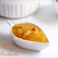 Glossy pineapple sweet pachadi with cashews served in a bowl beside spicy South Indian biryani