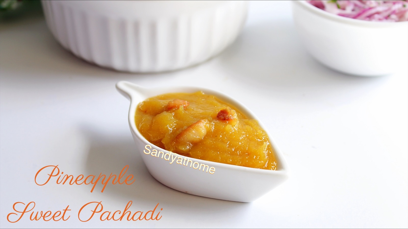 Glossy pineapple sweet pachadi with cashews served in a bowl beside spicy South Indian biryani
