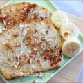 Close-up of golden coconut-coated eggless French toast with toasted coconut crust
