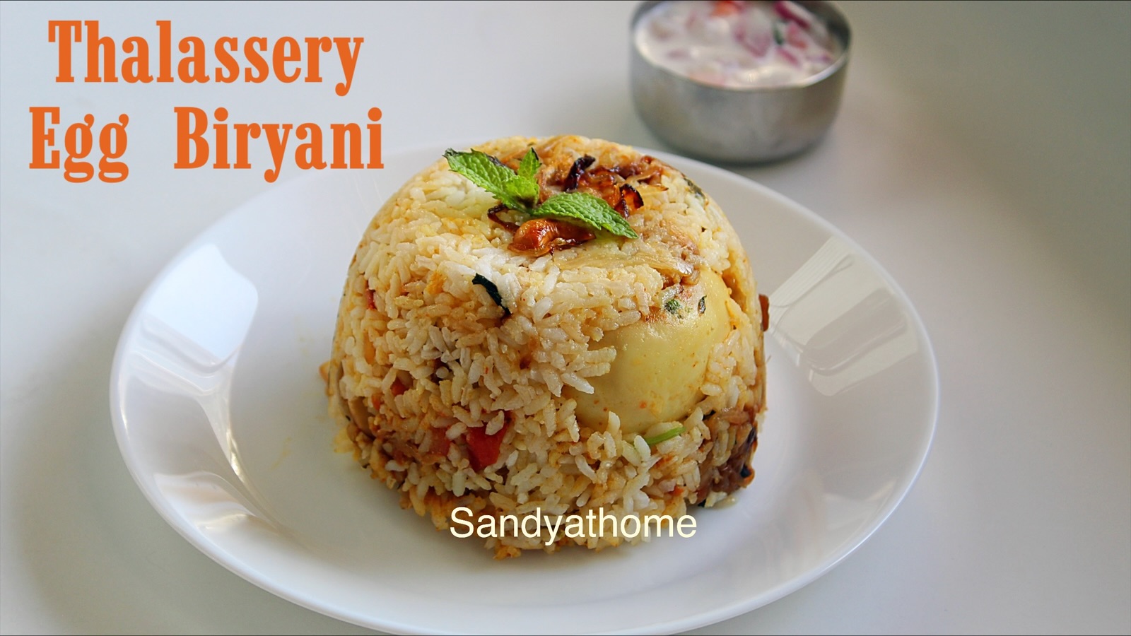 Authentic Thalassery style egg biryani made with Kerala jeerakasala rice, layered with masala and served with fried onions.
