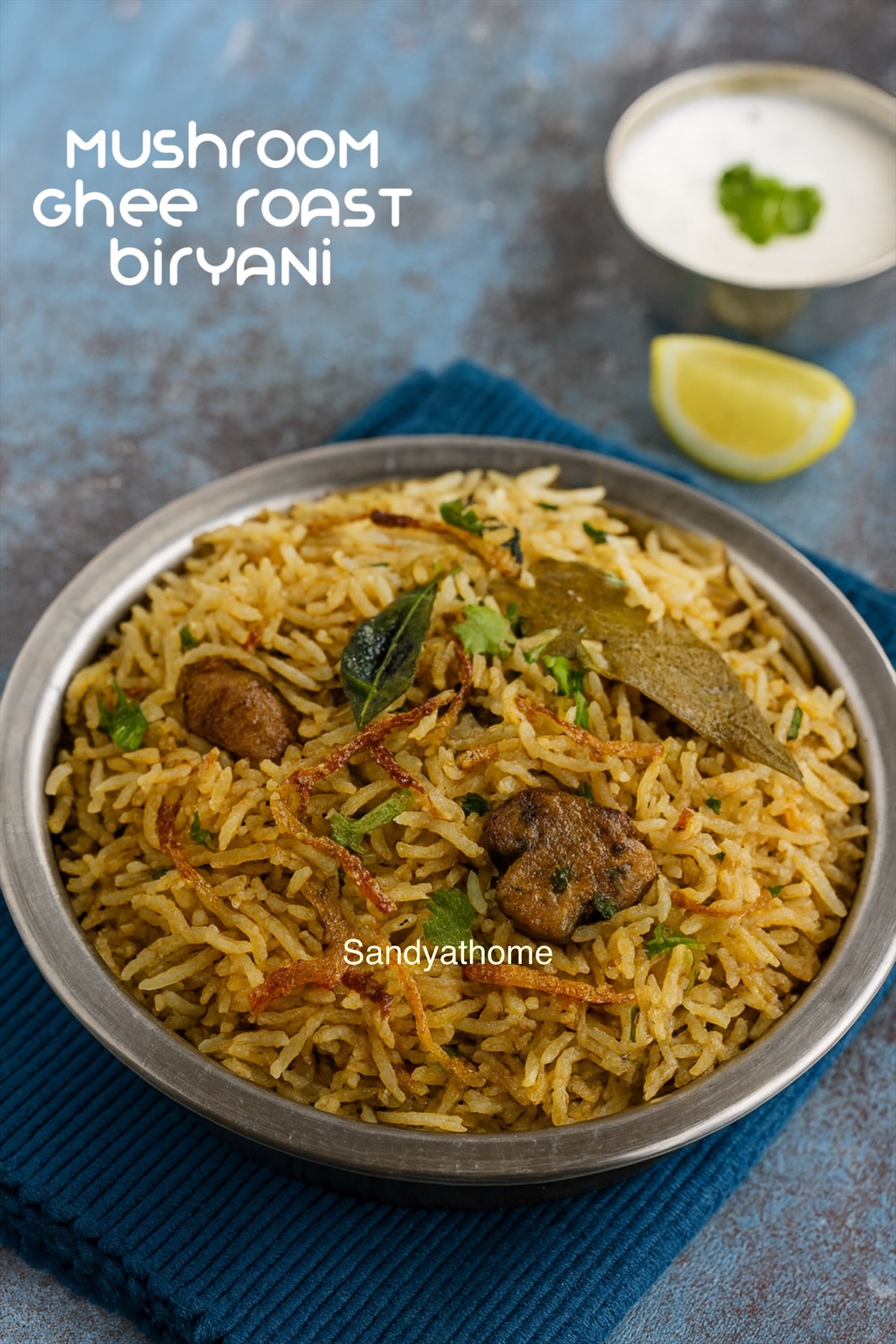 Andhra-style mushroom ghee roast biryani served in a rustic bowl, garnished with fried onions, mint, and cashews, with visible long basmati rice grains.