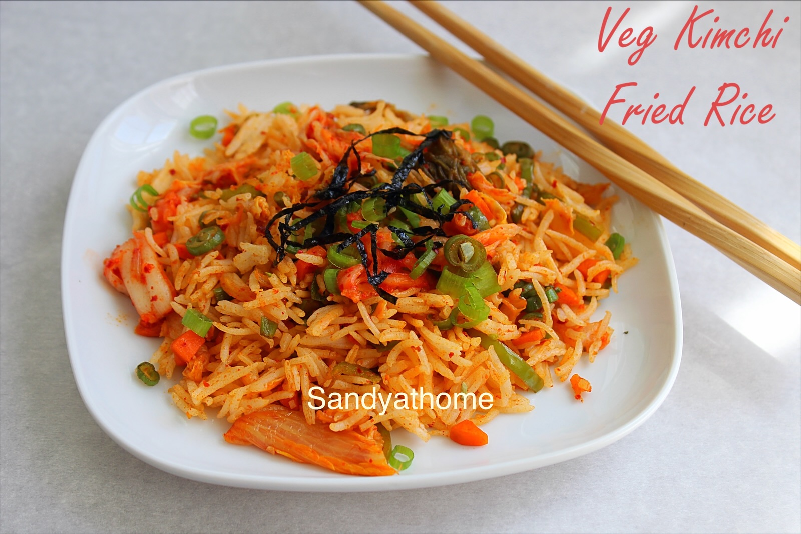 Easy Korean–Indian fusion dish of kimchi fried rice with basmati rice, vegetables, and seaweed topping.