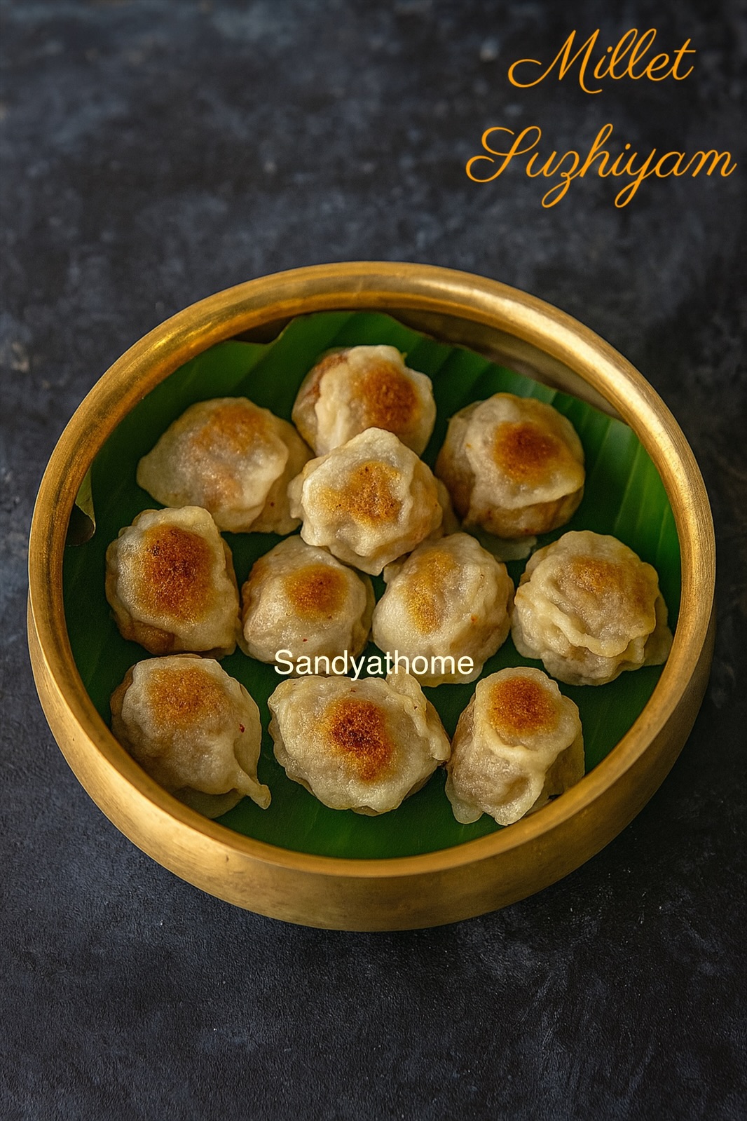 Close-up of thinai suzhiyam showing soft jaggery chana dal filling with crispy outer layer